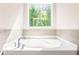 Corner garden bathtub with large window overlooking trees at 134 Henley St, Canton, GA 30114