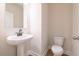 Small bathroom with pedestal sink and toilet at 134 Henley St, Canton, GA 30114