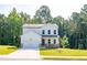 Two-story house with white siding, stone accents, and a two-car garage at 134 Henley St, Canton, GA 30114
