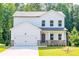 Two-story house with white siding, stone accents, and a two-car garage at 134 Henley St, Canton, GA 30114