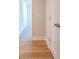 Hallway with wood-look flooring and access to bedrooms at 134 Henley St, Canton, GA 30114