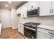 White kitchen with built-in microwave and stainless steel oven at 134 Henley St, Canton, GA 30114
