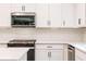 Close-up of kitchen range, microwave and white cabinets at 134 Henley St, Canton, GA 30114