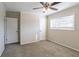 Bedroom with ceiling fan, neutral walls, carpet, and ample closet space at 6230 Kensington Ct, Austell, GA 30106