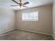 Well-lit bedroom with ceiling fan, neutral walls, and carpet flooring at 6230 Kensington Ct, Austell, GA 30106