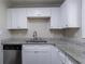 Newly renovated kitchen with white cabinets and granite countertops at 6230 Kensington Ct, Austell, GA 30106