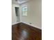 Bedroom with dark hardwood floors and access to bathroom at 2534 Creekview Sw Dr, Marietta, GA 30008