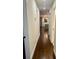 Long hallway with dark hardwood floors leading to kitchen and bathroom at 2534 Creekview Sw Dr, Marietta, GA 30008