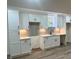 Newly renovated basement kitchen with white shaker cabinets and gray tile backsplash at 2534 Creekview Sw Dr, Marietta, GA 30008