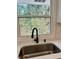 Modern kitchen sink with black faucet and white countertop at 2534 Creekview Sw Dr, Marietta, GA 30008