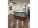 Modern kitchen with gray island and hardwood floors at 2534 Creekview Sw Dr, Marietta, GA 30008
