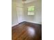 Bright bedroom with dark hardwood floors and spacious closet at 2534 Creekview Sw Dr, Marietta, GA 30008