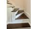 Modern staircase with dark wood treads and white risers at 2534 Creekview Sw Dr, Marietta, GA 30008