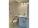 Basement bathroom with white vanity, subway tile shower, and a white toilet at 2534 Creekview Sw Dr, Marietta, GA 30008