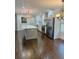 Renovated kitchen with island, stainless steel appliances, and dark hardwood floors at 2534 Creekview Sw Dr, Marietta, GA 30008