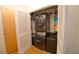 Stacked washer and dryer in a well-organized closet at 400 W Peachtree Nw St # 1713, Atlanta, GA 30308