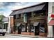 Atkins Park restaurant in a brick building, with a dark wood facade and signage at 1281 Avalon Ne Pl, Atlanta, GA 30306