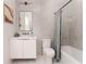 Modern bathroom with gray tile, white vanity, and bathtub at 1281 Avalon Ne Pl, Atlanta, GA 30306