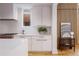 Modern kitchen with white cabinets and unique wood wall at 1281 Avalon Ne Pl, Atlanta, GA 30306