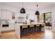 Modern kitchen with white cabinets, island, and hardwood floors at 1281 Avalon Ne Pl, Atlanta, GA 30306