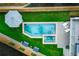 Aerial view of a luxurious pool and spa with surrounding patio and lush landscaping at 1281 Avalon Ne Pl, Atlanta, GA 30306