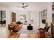 Bright living room features hardwood floors, a leather sofa, and a fireplace at 1281 Avalon Ne Pl, Atlanta, GA 30306