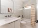 Modern bathroom with gray tile, white vanity, and bathtub at 1281 Avalon Ne Pl, Atlanta, GA 30306