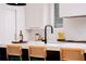 Modern kitchen features white cabinetry, quartz countertops, and a black faucet at 1281 Avalon Ne Pl, Atlanta, GA 30306
