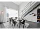 Spacious dining area with hardwood floors, large windows and modern staircase at 400 17Th Nw St # 2431, Atlanta, GA 30363
