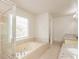 Bathroom with a large garden tub, shower, and granite vanity at 1851 Furlong Run, Lawrenceville, GA 30043