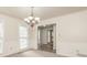 Elegant dining room with chandelier and hardwood floors at 1851 Furlong Run, Lawrenceville, GA 30043