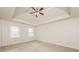 Spacious bedroom with carpeted floor, two windows, and a ceiling fan at 1851 Furlong Run, Lawrenceville, GA 30043