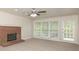 Bright living room with brick fireplace and access to a deck at 1851 Furlong Run, Lawrenceville, GA 30043