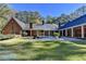 Large backyard featuring a pool, brick patio, and surrounding trees at 2701 Stilesboro Nw Ln, Acworth, GA 30101