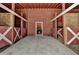 Interior view of horse barn with stalls and a car parked inside at 2701 Stilesboro Nw Ln, Acworth, GA 30101