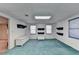 Spacious basement room with teal carpet and built-in shelving at 2701 Stilesboro Nw Ln, Acworth, GA 30101
