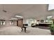 Spacious basement with a library wall, a round table, and carpeted floors at 2701 Stilesboro Nw Ln, Acworth, GA 30101