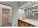 Elegant bathroom with single vanity, large mirror, and a view to the bathtub area at 2701 Stilesboro Nw Ln, Acworth, GA 30101