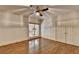 Bright bedroom with hardwood floors, ceiling fan, and French doors to a private balcony at 2701 Stilesboro Nw Ln, Acworth, GA 30101