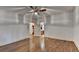 Large bedroom with gleaming hardwood floors, a ceiling fan, and direct access to an en-suite bathroom at 2701 Stilesboro Nw Ln, Acworth, GA 30101