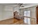 Charming bedroom featuring hardwood floors, a ceiling fan, and large windows at 2701 Stilesboro Nw Ln, Acworth, GA 30101