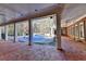 Covered patio with brick flooring, columns, ceiling fan, and access to a pool at 2701 Stilesboro Nw Ln, Acworth, GA 30101