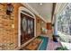 Brick home with double door entry, covered porch, and rocking chairs at 2701 Stilesboro Nw Ln, Acworth, GA 30101