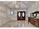 Grand foyer with marble flooring, elegant chandelier, and double doors at 2701 Stilesboro Nw Ln, Acworth, GA 30101