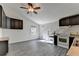 Open kitchen with dark cabinets, white appliances, and gray wood-look flooring at 2701 Stilesboro Nw Ln, Acworth, GA 30101