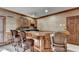 Custom wet bar with ample seating and plenty of storage for entertaining at 2701 Stilesboro Nw Ln, Acworth, GA 30101