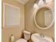Clean bathroom with white vanity, round mirror, and toilet at 3034 Brookgreen Trl, Lawrenceville, GA 30043