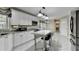 Kitchen with white cabinets, granite countertops and an island with seating at 3034 Brookgreen Trl, Lawrenceville, GA 30043
