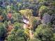 House nestled in colorful autumn woods at 810 Mcconnell Rd, Powder Springs, GA 30127