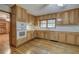 Kitchen with light wood cabinets, hardwood floors, and a view into the living room at 810 Mcconnell Rd, Powder Springs, GA 30127